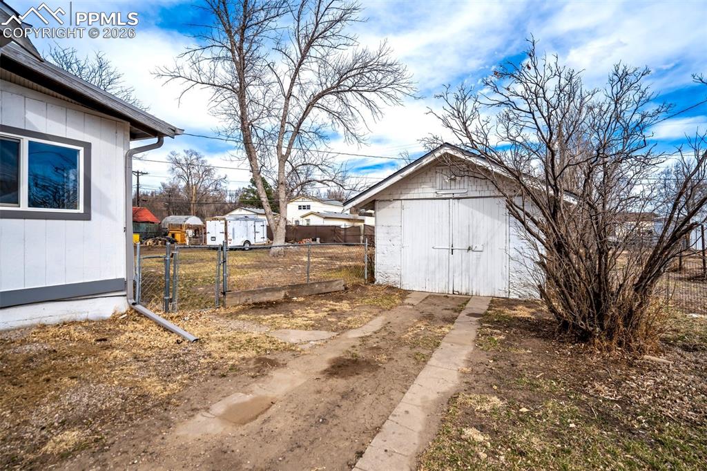 Image 36 of 38: Detached garage offers convenient storage or workshop potential, with addit