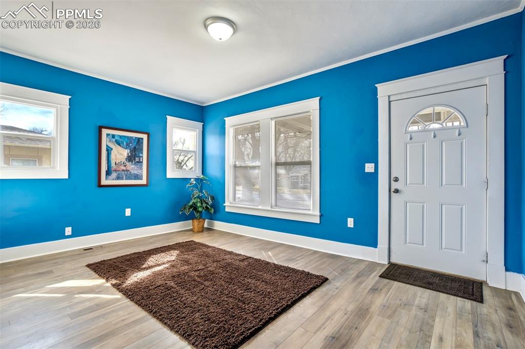 Image 4 of 38: Bright and inviting living room featuring abundant natural light, fresh mod