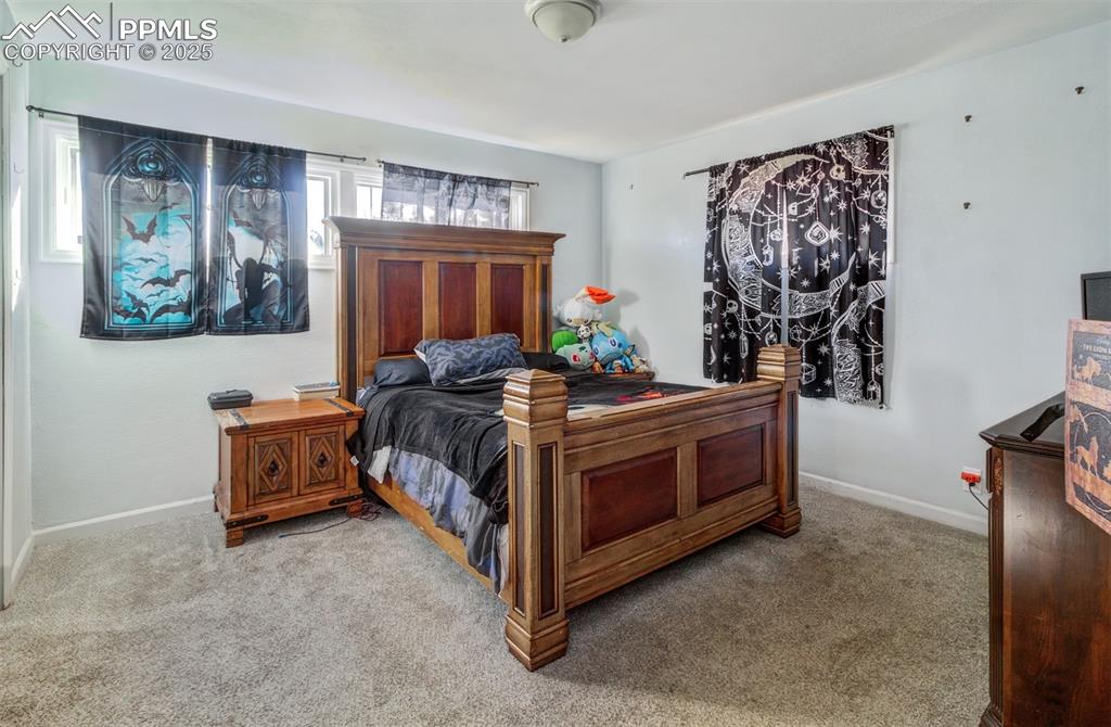 Image 16 of 29: Bedroom with baseboards and carpet flooring