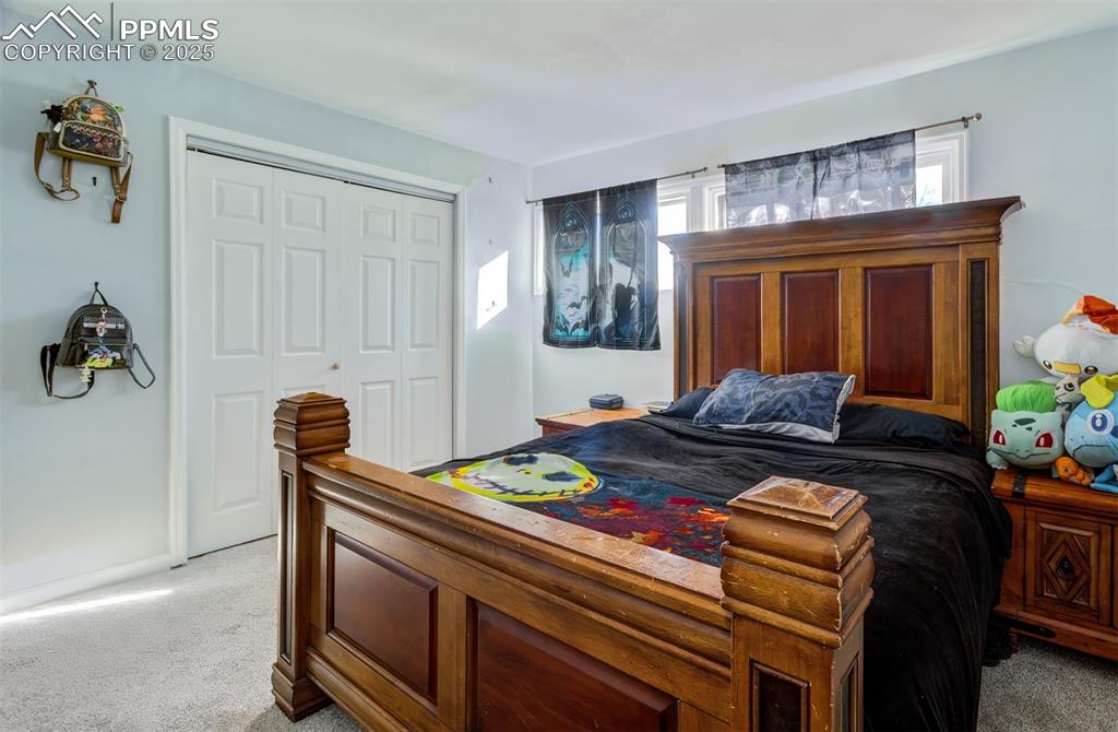 Image 17 of 29: Bedroom with a closet and light colored carpet