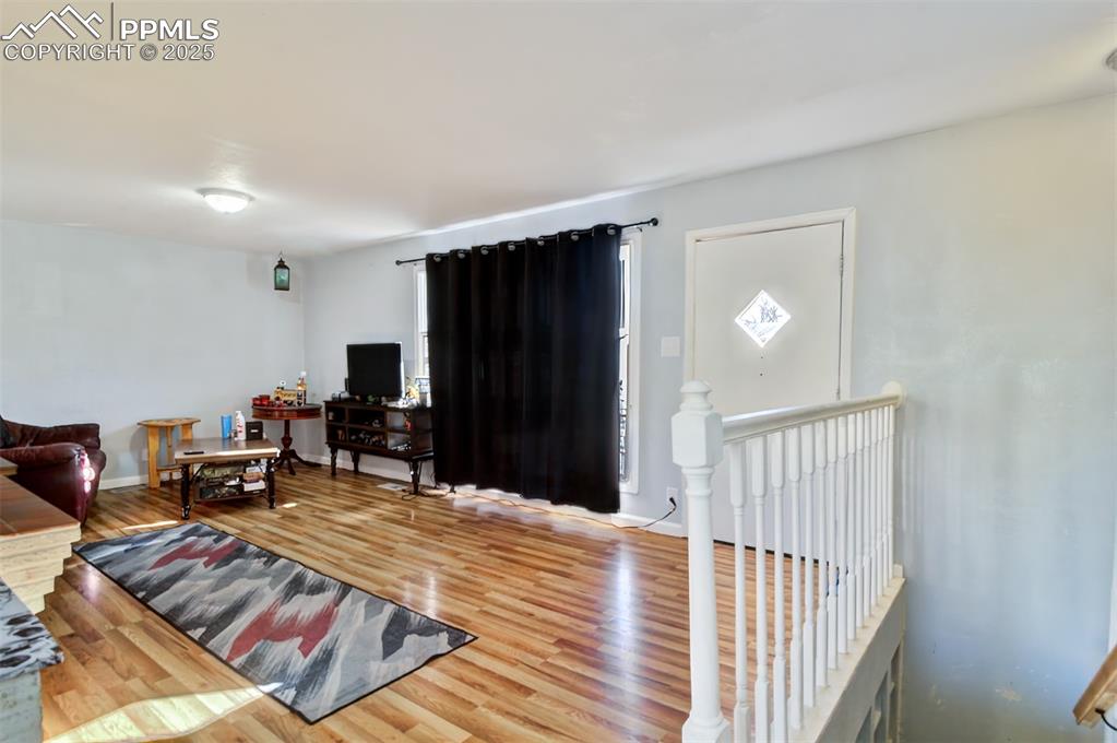 Image 3 of 29: Living area featuring baseboards and wood finished floors