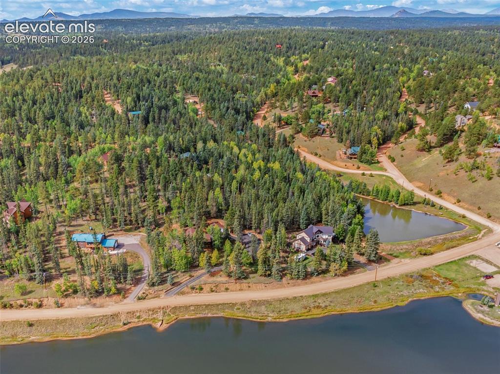 Image 29 of 37: Ariel view of property and lake.