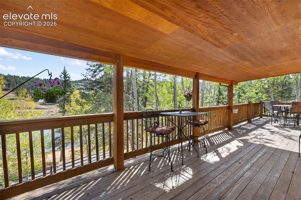 Image 6 of 37: Covered porch looking at lake