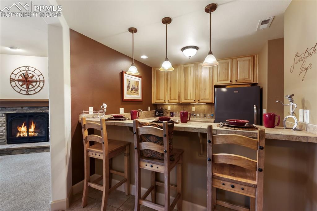 Image 24 of 44: Basement wet bar and kitchenette