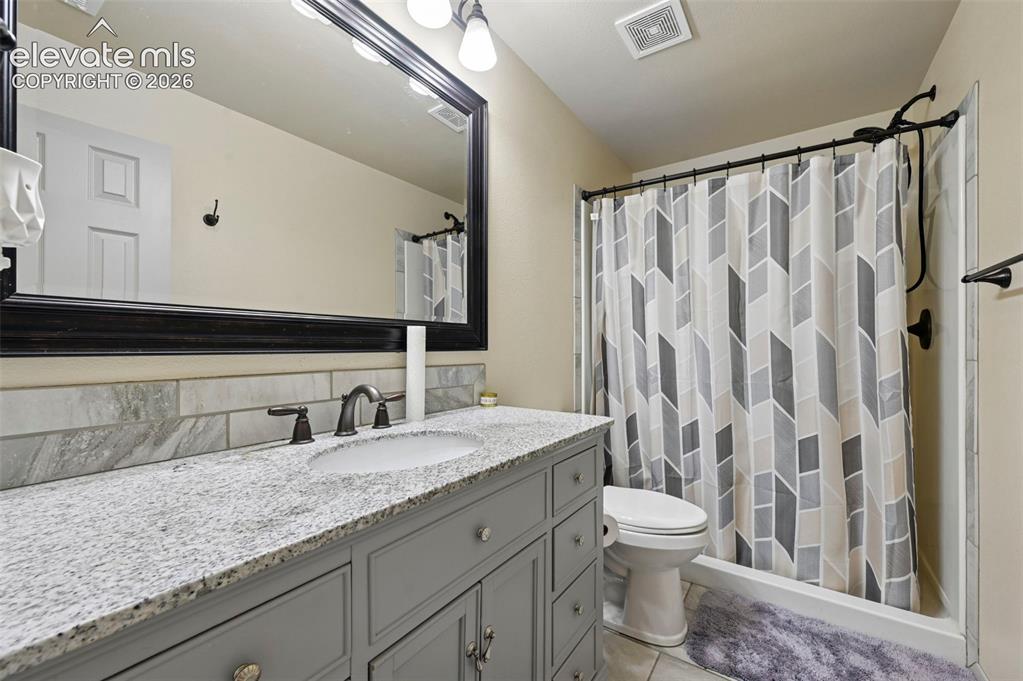 Image 10 of 37: Bathroom vanity featuring a light-toned countertop, under-mount sink, and d