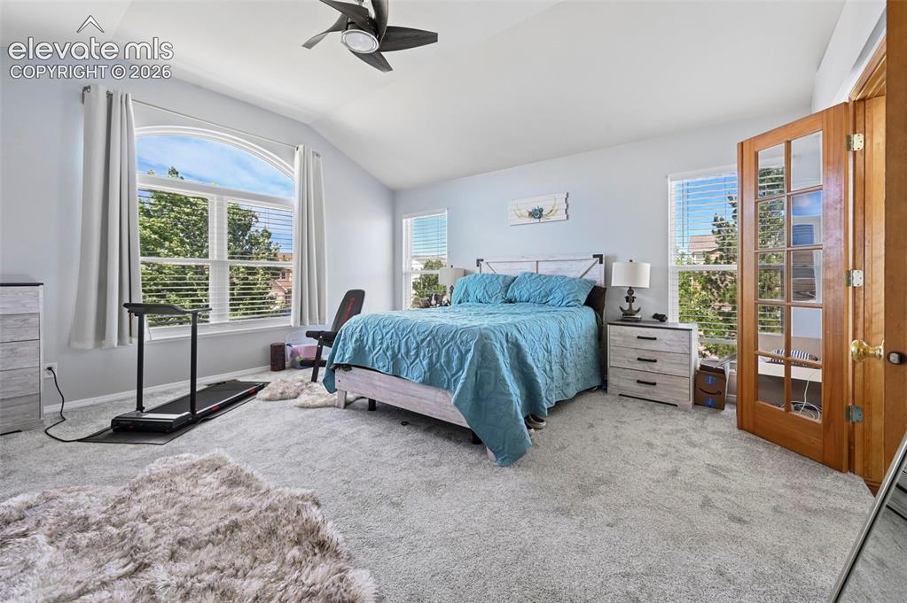 Image 18 of 37: Spacious interior featuring vaulted ceilings and light grey carpeting
