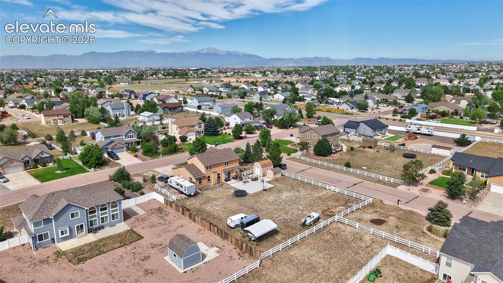 Image 29 of 37: Expansive residential neighborhood with distant mountain ranges