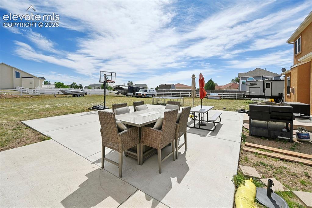 Image 33 of 37: Expansive concrete patio offering a broad outdoor living area