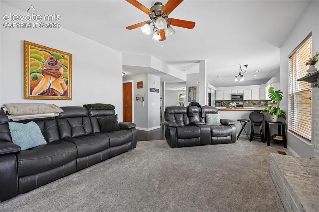 Image 4 of 37: Open-concept living space featuring light gray wall paint and matching carp