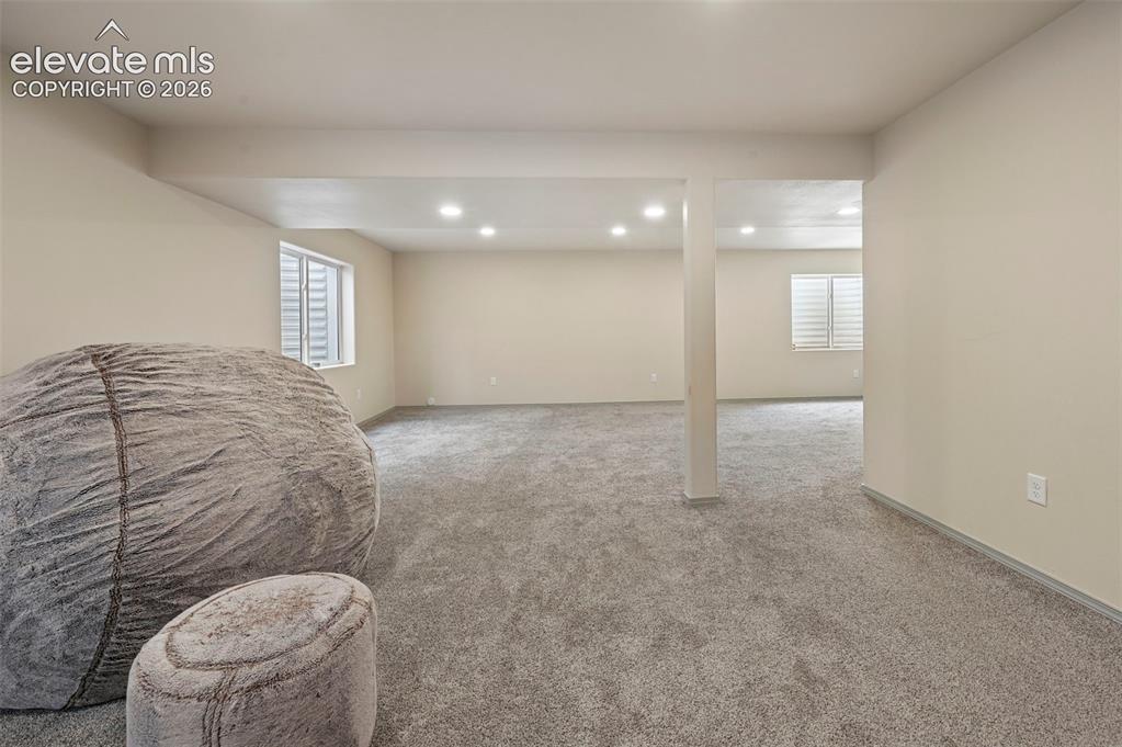 Image 8 of 37: Spacious room featuring neutral paint, gray carpeting, recessed lighting, a