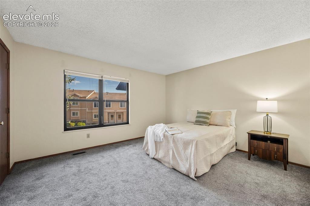 Image 14 of 27: Upper level primary bedroom