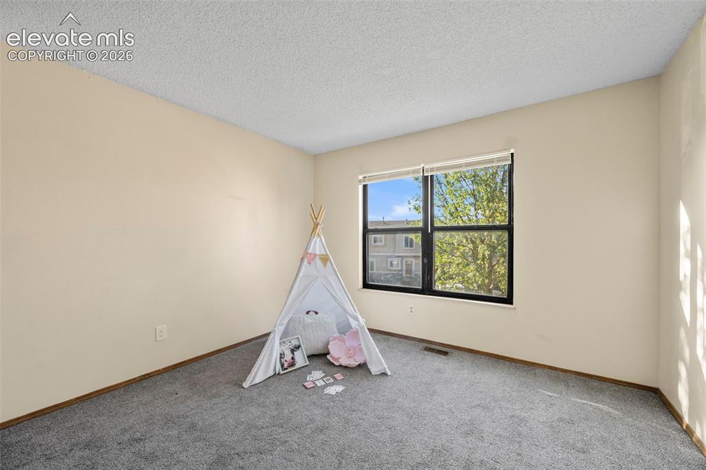 Image 17 of 27: Upper level bedroom