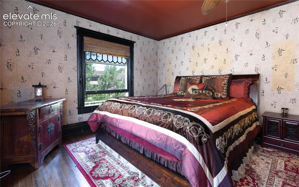 Image 14 of 38: Back side bedroom looks out over shady backyard