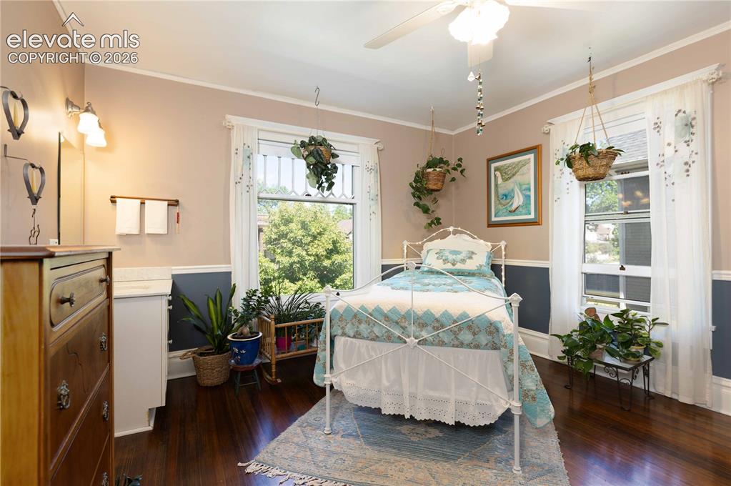 Image 14 of 37: Large windows face forward from this bedroom