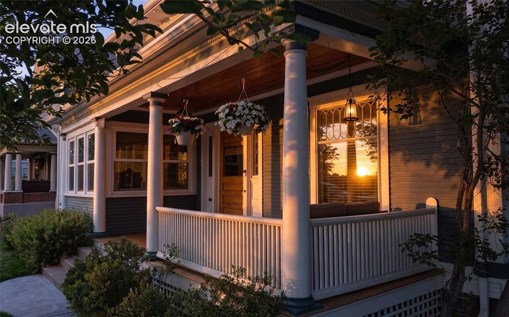 Image 29 of 37: Wide front porch for enjoying sunset evenings