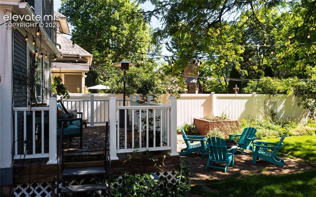 Image 32 of 37: A deck plus a lower brick patio for endless summer entertaining