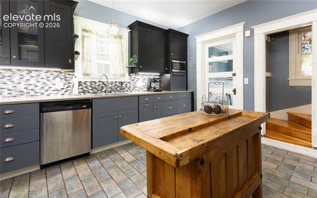 Image 8 of 37: Completely updated kitchen with access to back laundry and second staircase
