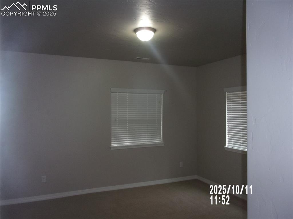 Image 10 of 21: Carpeted empty room with baseboards