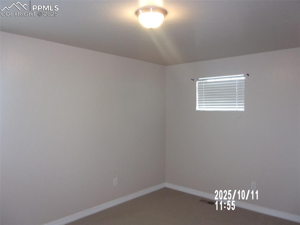Image 12 of 21: Empty room with baseboards and carpet flooring