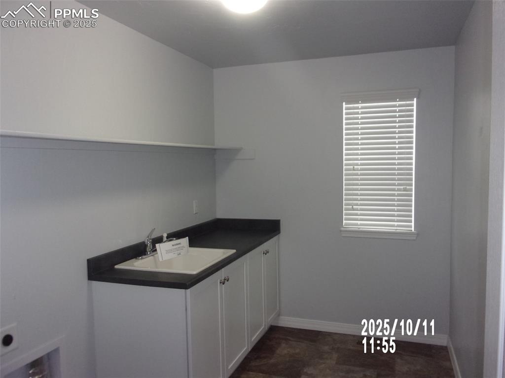 Image 14 of 21: Laundry room featuring electric dryer hookup and cabinet space
