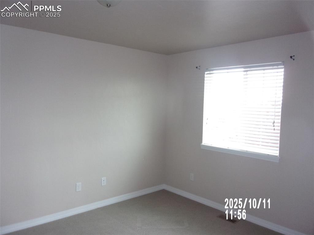 Image 16 of 21: Carpeted spare room featuring baseboards