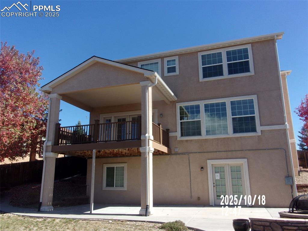 Image 2 of 21: Back of house with a patio and stucco siding