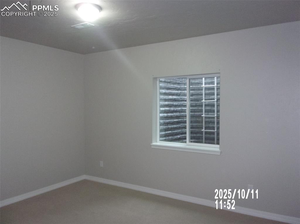 Image 8 of 21: Unfurnished room featuring baseboards and carpet flooring