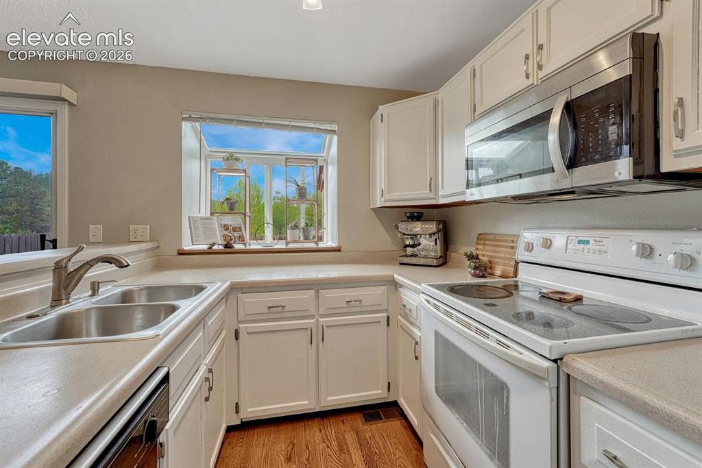 Image 13 of 50: Refrigerator, range oven, microwave, and dishwasher included