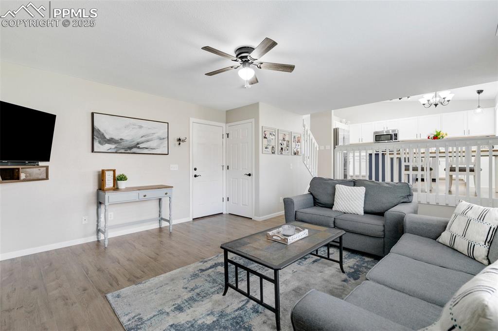 Image 16 of 27: Living room featuring wood finished floors and ceiling fan