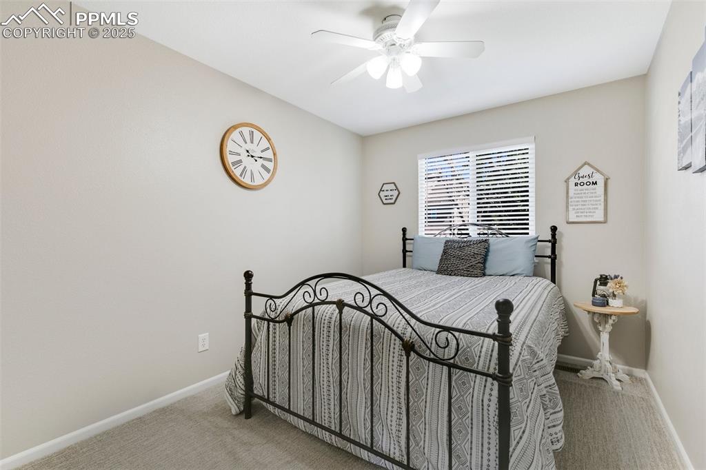 Image 17 of 27: Carpeted bedroom featuring a ceiling fan and baseboards