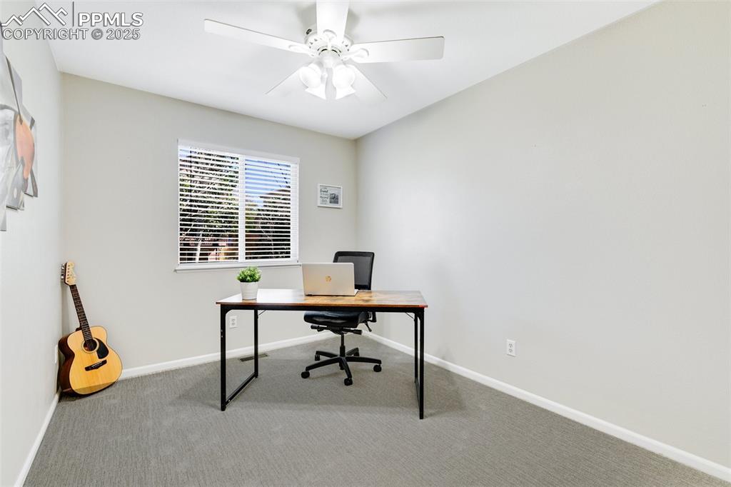 Image 18 of 27: Home office with carpet and ceiling fan