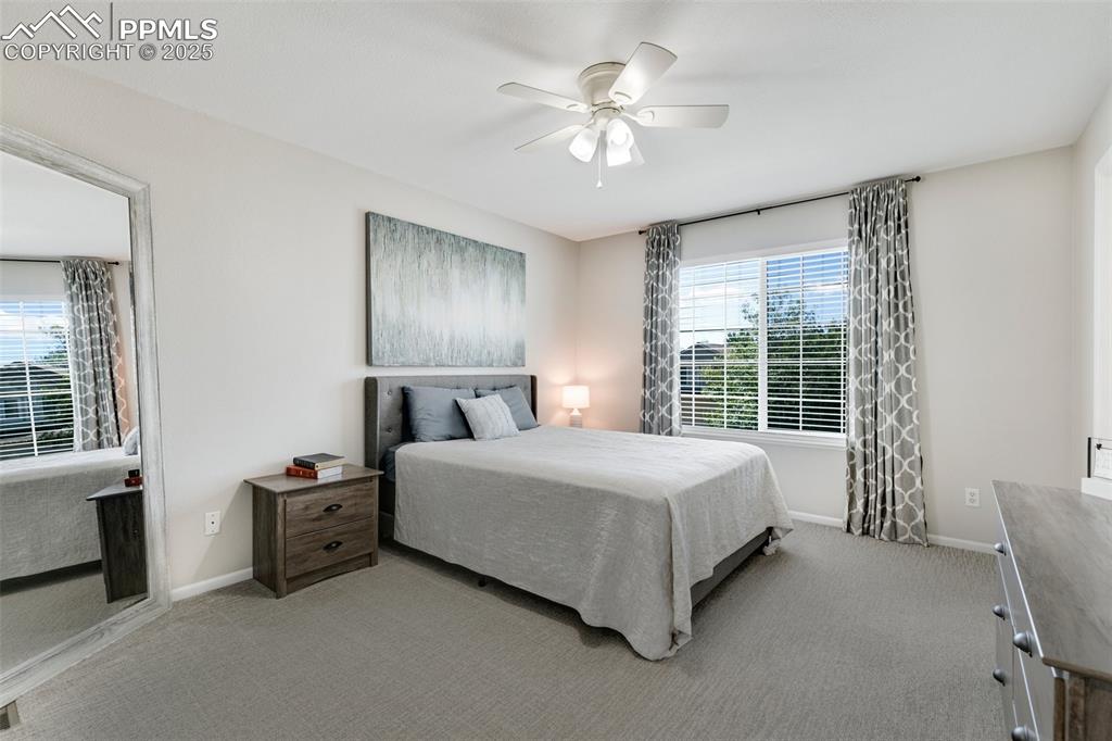 Image 20 of 27: Carpeted bedroom featuring ceiling fan and baseboards