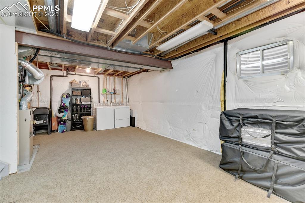 Image 24 of 27: Unfinished below grade area with independent washer and dryer