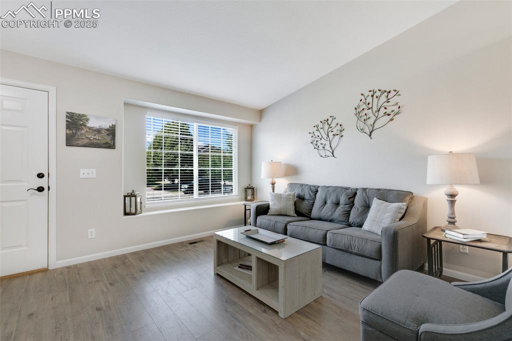 Image 5 of 27: Living room featuring light wood-style floors and baseboards
