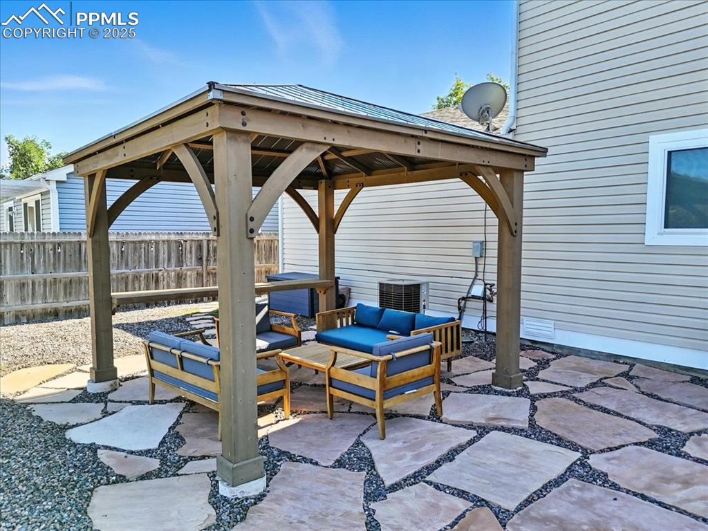 Image 21 of 33: View of patio featuring a gazebo and an outdoor hangout area