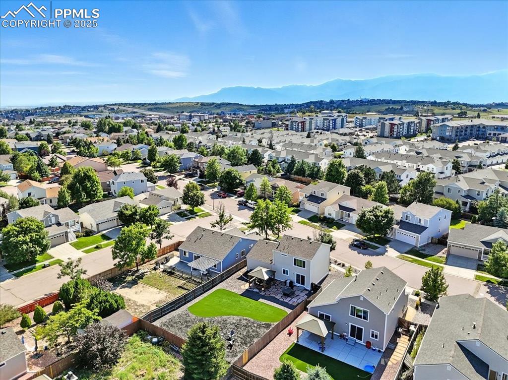 Image 31 of 33: Aerial view of residential area with a mountain backdrop