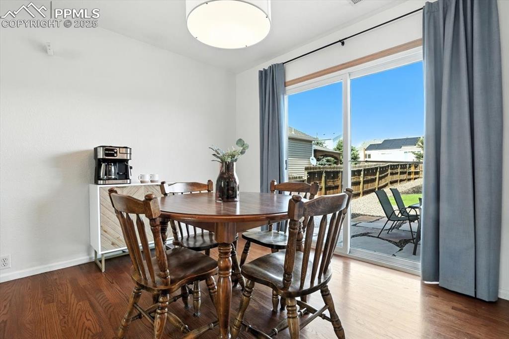 Image 6 of 33: Dining room featuring wood finished floors and baseboards