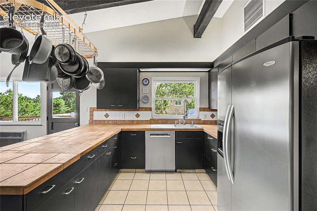Image 15 of 50: The kitchen highlights its abundant counter space and the continuation of t