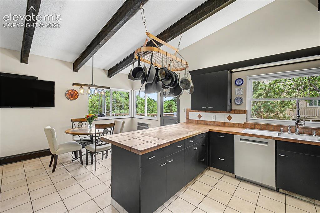 Image 16 of 50: Your eye is drawn straight through to the breakfast nook, reinforcing the