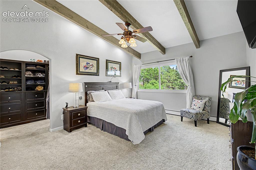 Image 18 of 50: A built-in arched closet nook adds a custom touch to a primary suite that f
