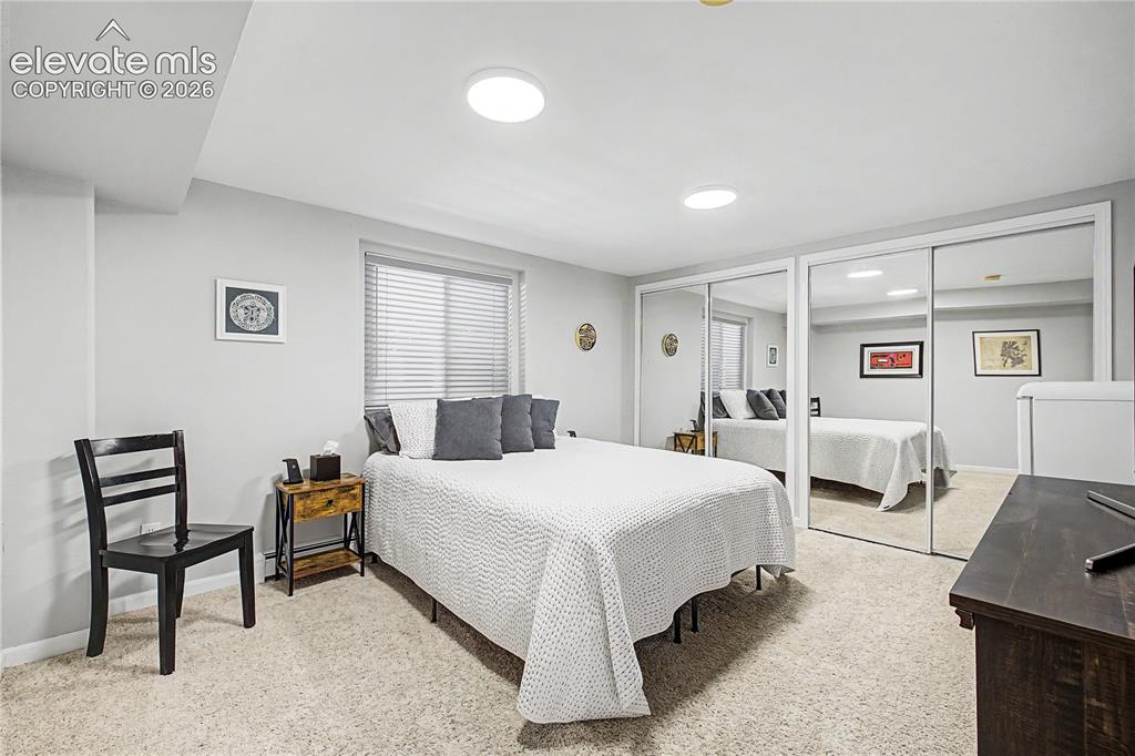 Image 26 of 50: Even on the lower level, a window well brings in natural light, keeping thi