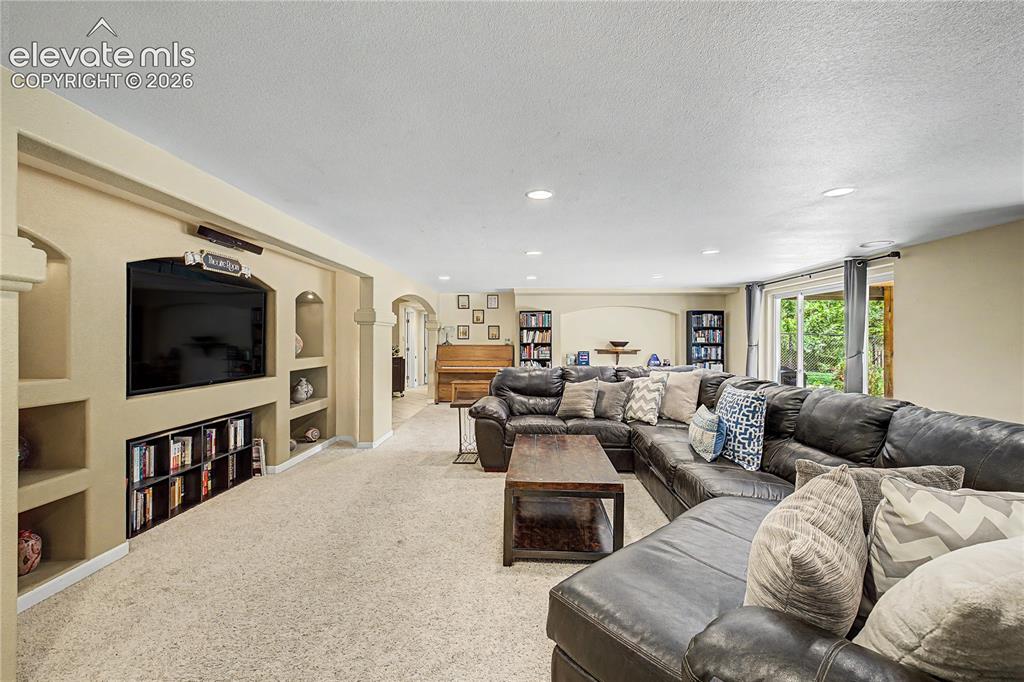 Image 28 of 50: A built-in "Theatre Room" media wall, complete with custom display niches,