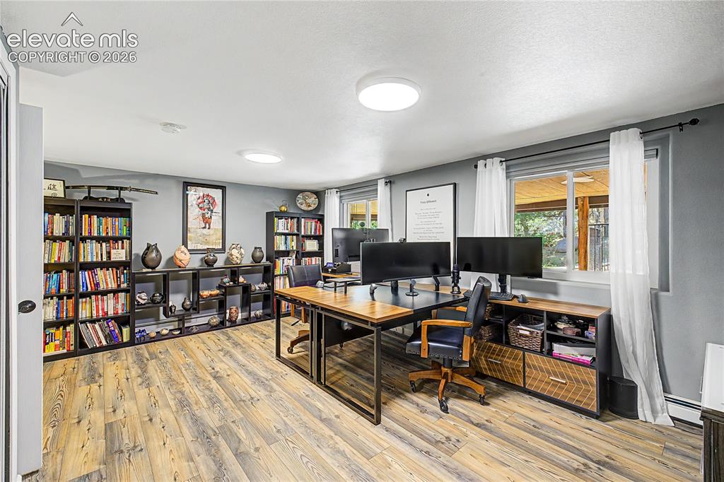 Image 35 of 50: A dedicated home office on the lower level offers space for an additional b