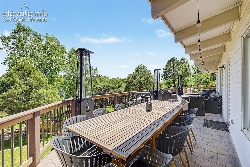 Image 38 of 50: From the far end of the deck, the view opens up over the pond and backyard