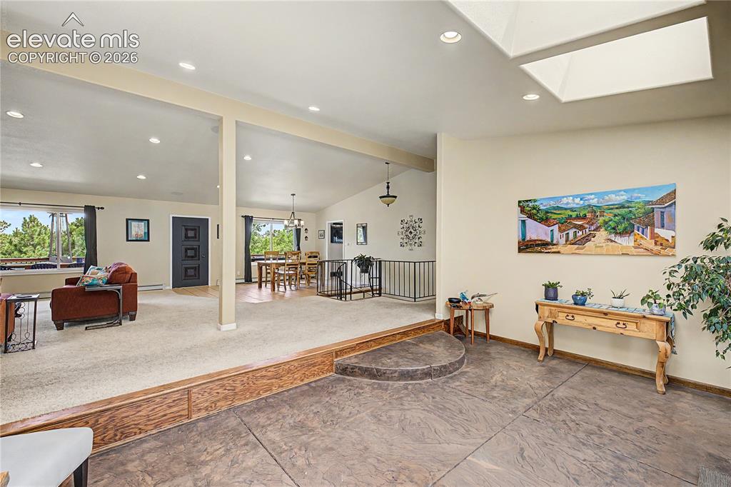 Image 5 of 50: A subtle step transitions guests from the entry into the open living space