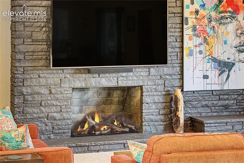 Image 8 of 50: A closer look at the fireplace showcases the craftsmanship of the hand-stac