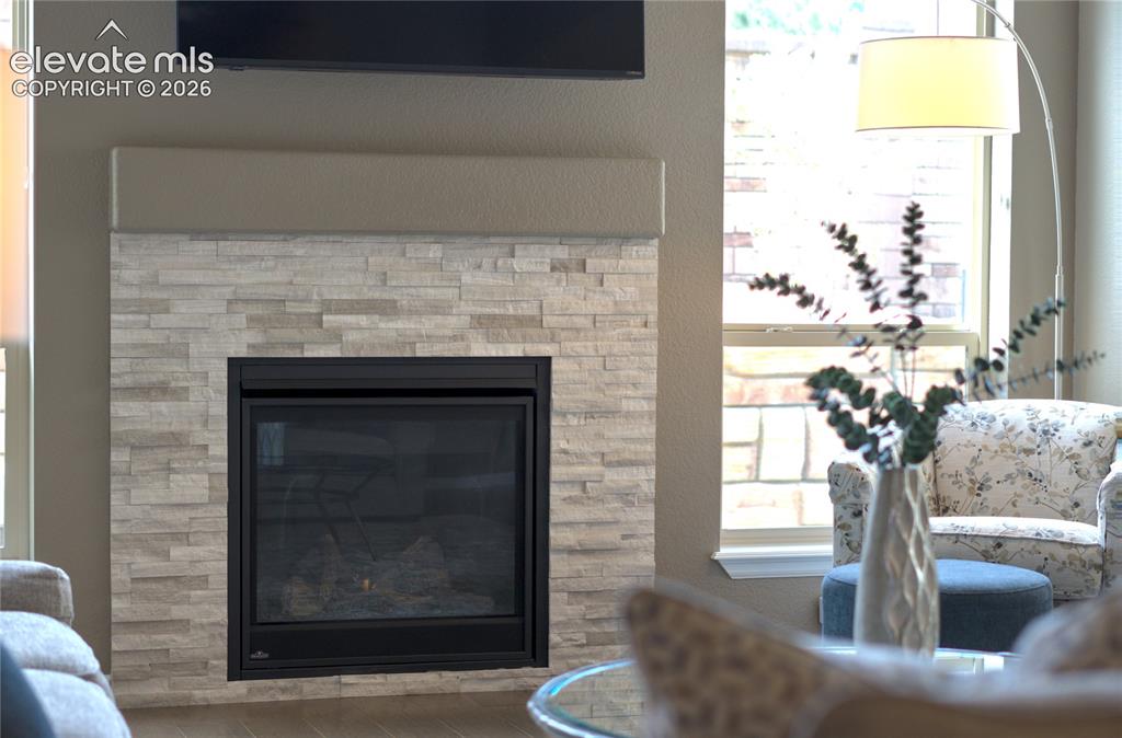 Image 12 of 48: A gas fireplace anchors the room, creating a cozy focal point throughout Co