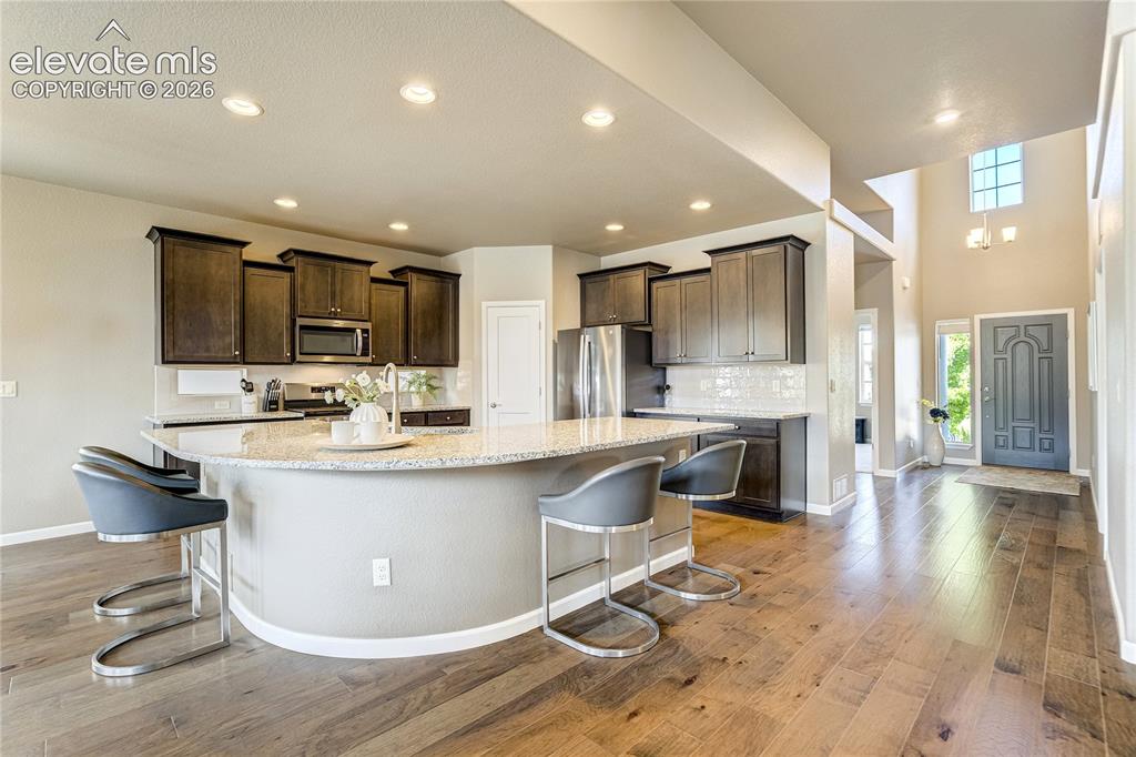 Image 15 of 48: Granite countertops, abundant cabinetry, stainless steel appliances + a gen