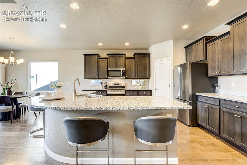 Image 16 of 48: Whether preparing meals or hosting friends, the expansive island provides b