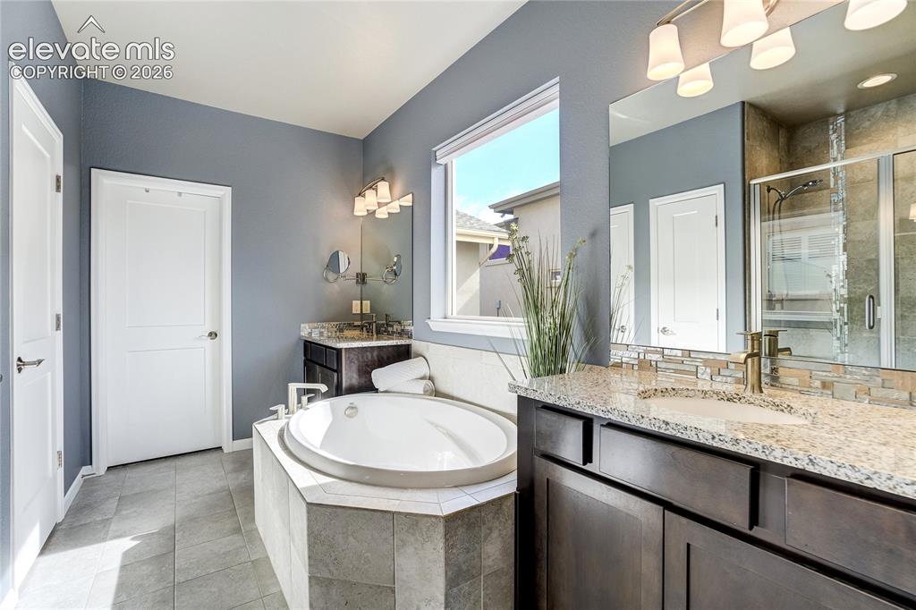 Image 26 of 48: vanities, a soaking tub + an oversized shower.